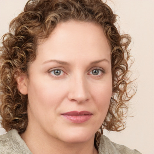 Joyful white young-adult female with medium  brown hair and green eyes