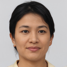 Joyful asian young-adult female with short  brown hair and brown eyes