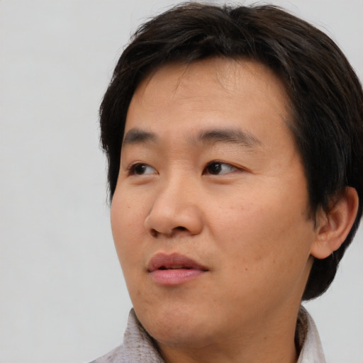 Neutral asian young-adult male with short  brown hair and brown eyes