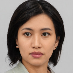 Neutral asian young-adult female with medium  black hair and brown eyes