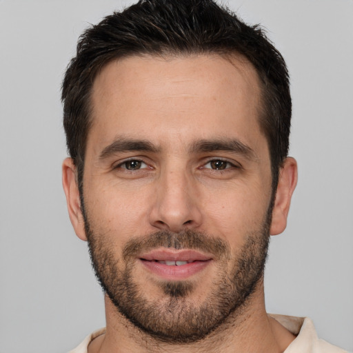 Joyful white young-adult male with short  brown hair and brown eyes