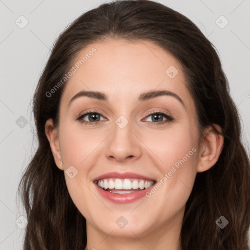 Joyful white young-adult female with long  brown hair and grey eyes