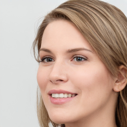 Joyful white young-adult female with long  brown hair and grey eyes