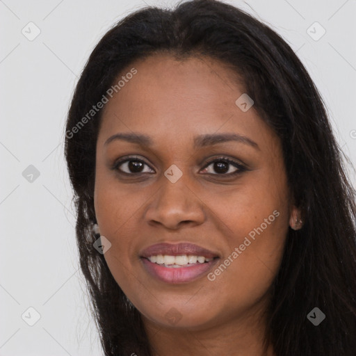 Joyful black young-adult female with long  brown hair and brown eyes