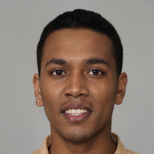 Joyful black young-adult male with short  black hair and brown eyes