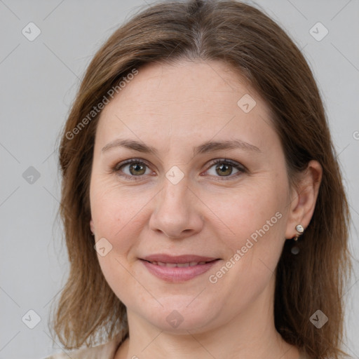 Joyful white adult female with medium  brown hair and grey eyes