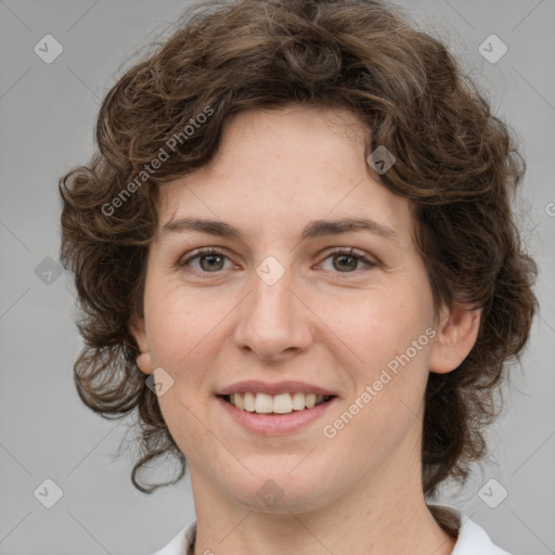 Joyful white young-adult female with medium  brown hair and green eyes