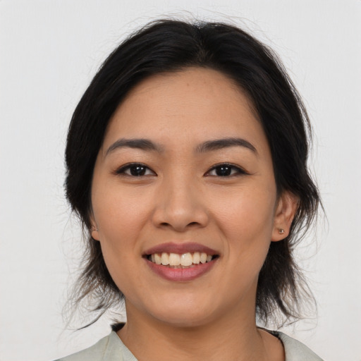 Joyful asian young-adult female with medium  black hair and brown eyes