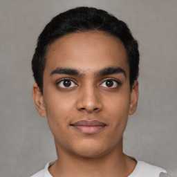 Joyful latino young-adult male with short  black hair and brown eyes