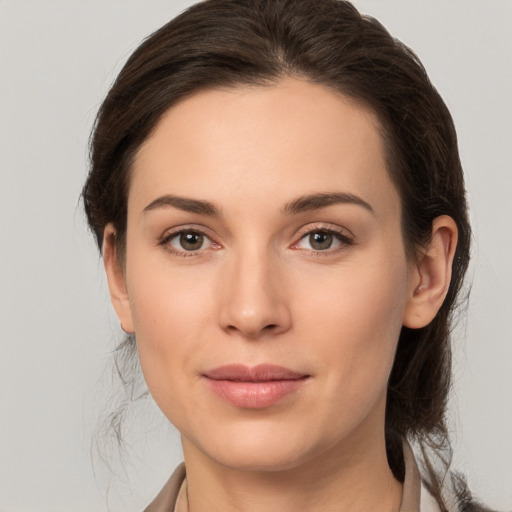 Joyful white young-adult female with medium  brown hair and brown eyes