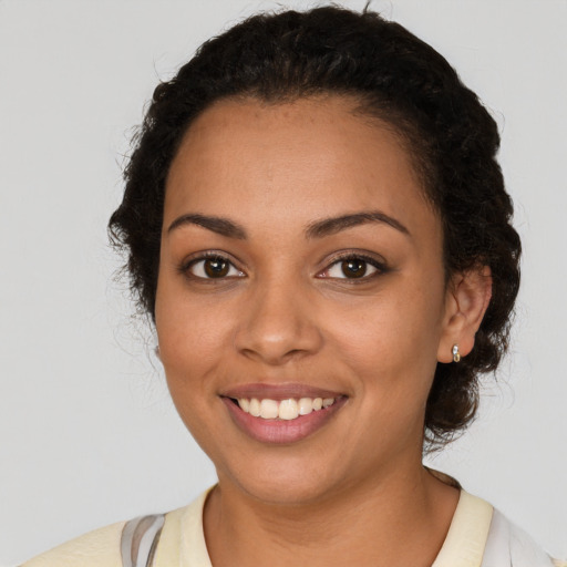 Joyful latino young-adult female with short  black hair and brown eyes