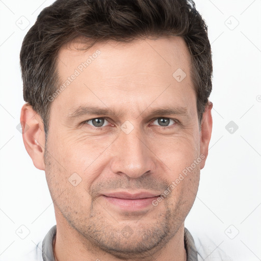 Joyful white adult male with short  brown hair and brown eyes