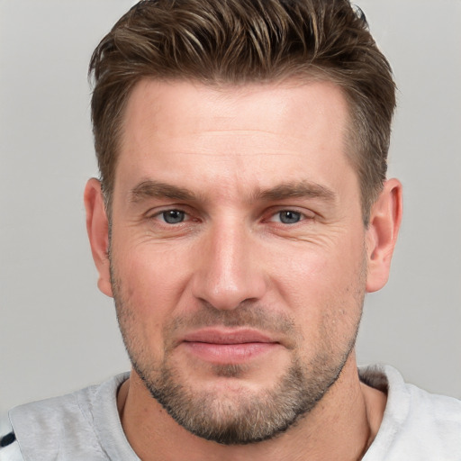 Joyful white adult male with short  brown hair and grey eyes