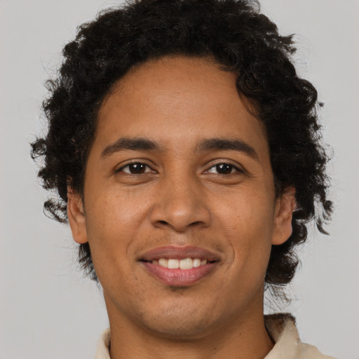 Joyful black young-adult male with short  brown hair and brown eyes