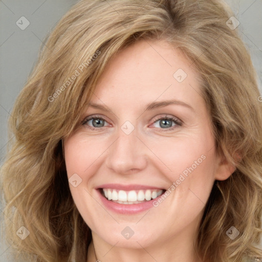 Joyful white young-adult female with long  brown hair and blue eyes