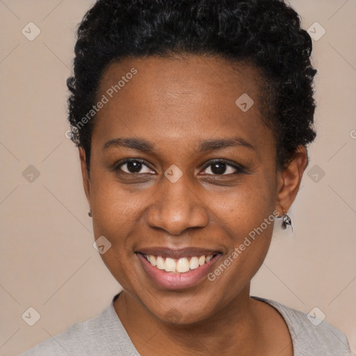 Joyful black young-adult female with short  black hair and brown eyes