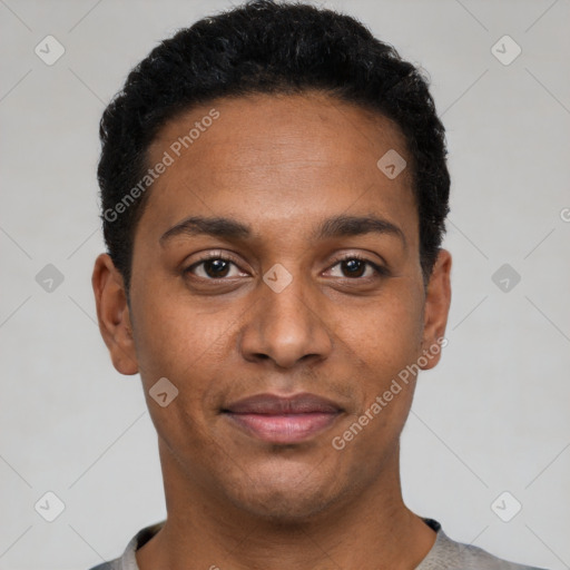 Joyful black young-adult male with short  black hair and brown eyes