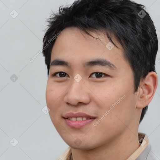 Joyful asian young-adult male with short  brown hair and brown eyes