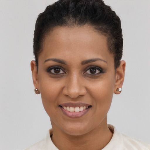 Joyful black young-adult female with short  brown hair and brown eyes