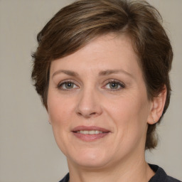 Joyful white adult female with medium  brown hair and grey eyes