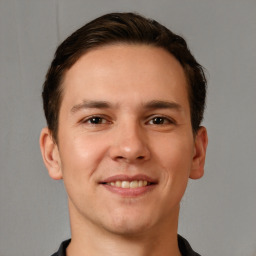 Joyful white young-adult male with short  brown hair and brown eyes