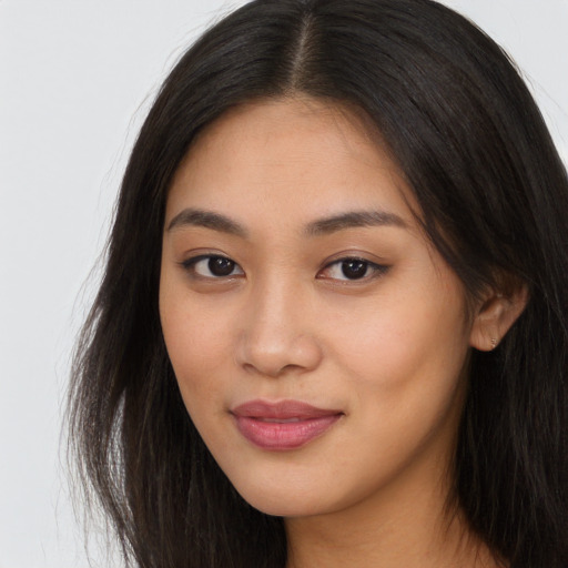 Joyful asian young-adult female with long  brown hair and brown eyes