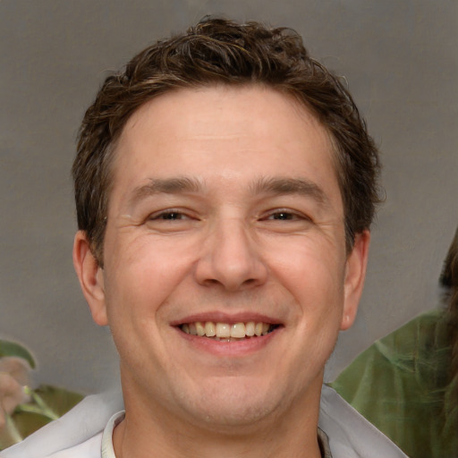 Joyful white adult male with short  brown hair and brown eyes