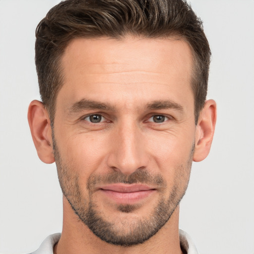 Joyful white adult male with short  brown hair and brown eyes