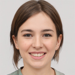 Joyful white young-adult female with medium  brown hair and brown eyes