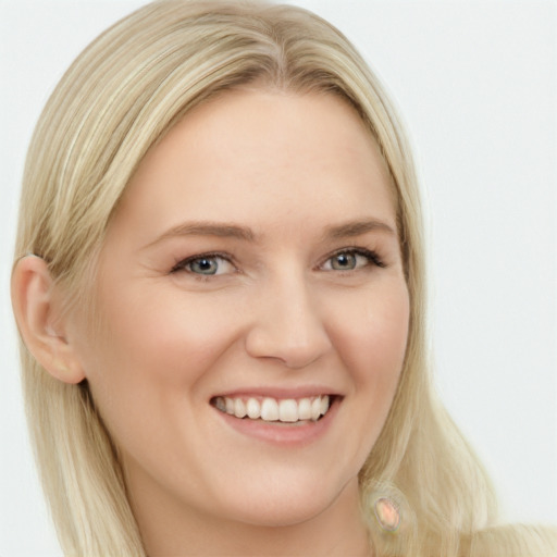 Joyful white young-adult female with long  blond hair and blue eyes