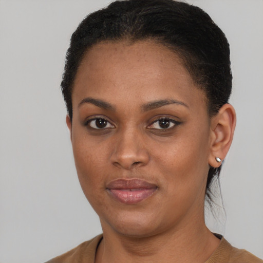 Joyful black young-adult female with short  brown hair and brown eyes