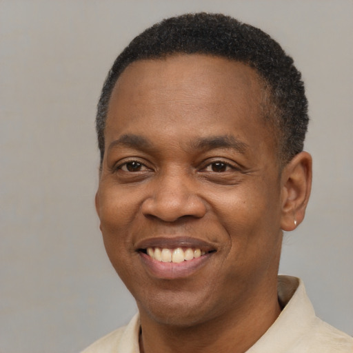 Joyful latino adult male with short  black hair and brown eyes
