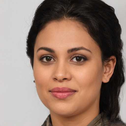 Joyful latino young-adult female with medium  brown hair and brown eyes