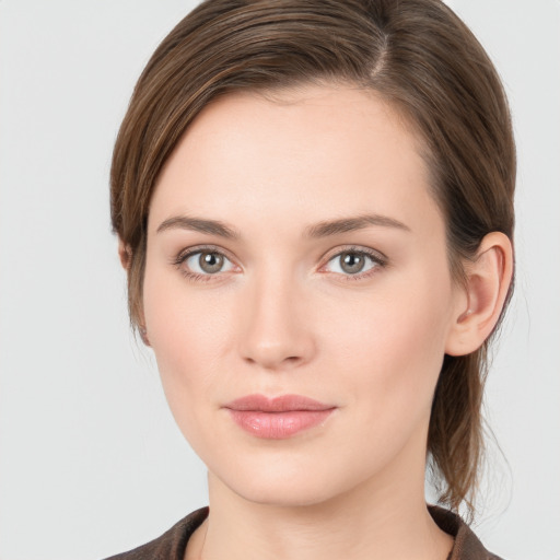 Joyful white young-adult female with medium  brown hair and grey eyes