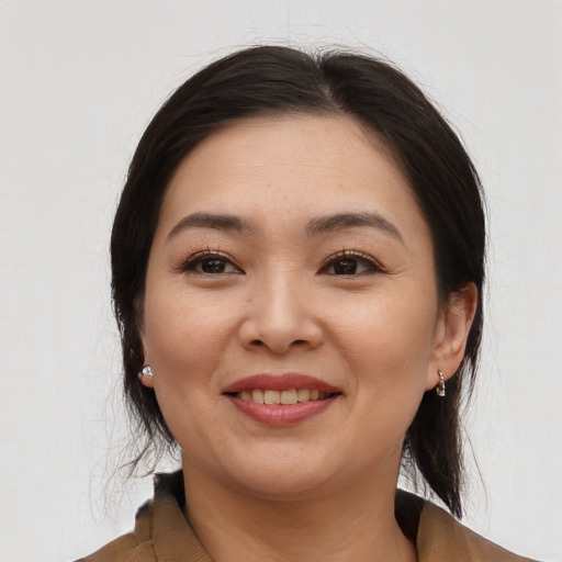 Joyful asian young-adult female with medium  brown hair and brown eyes