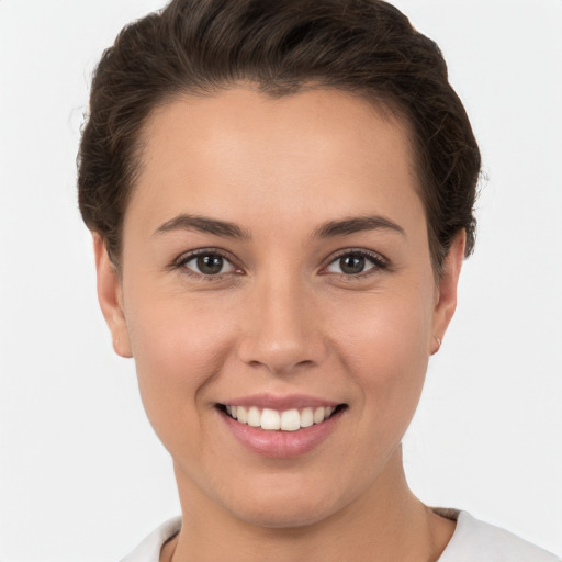 Joyful white young-adult female with short  brown hair and brown eyes