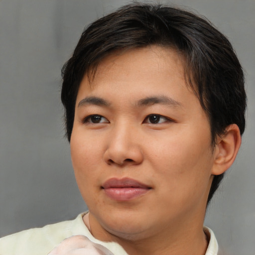 Joyful asian young-adult female with short  brown hair and brown eyes