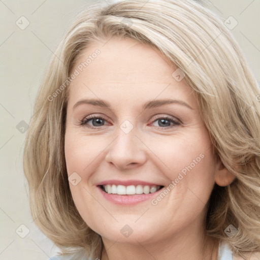 Joyful white young-adult female with medium  brown hair and blue eyes