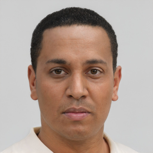 Joyful latino young-adult male with short  brown hair and brown eyes