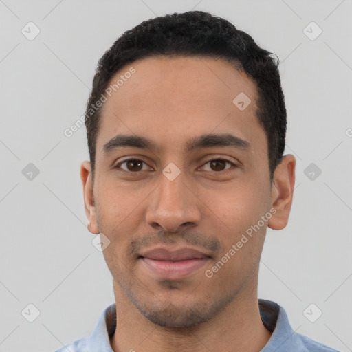 Joyful latino young-adult male with short  black hair and brown eyes