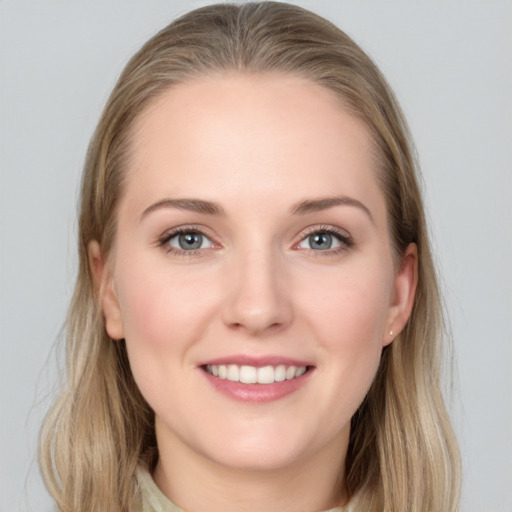 Joyful white young-adult female with long  brown hair and grey eyes