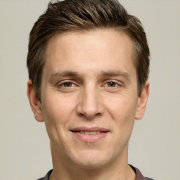 Joyful white adult male with short  brown hair and grey eyes