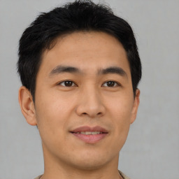 Joyful asian young-adult male with short  brown hair and brown eyes