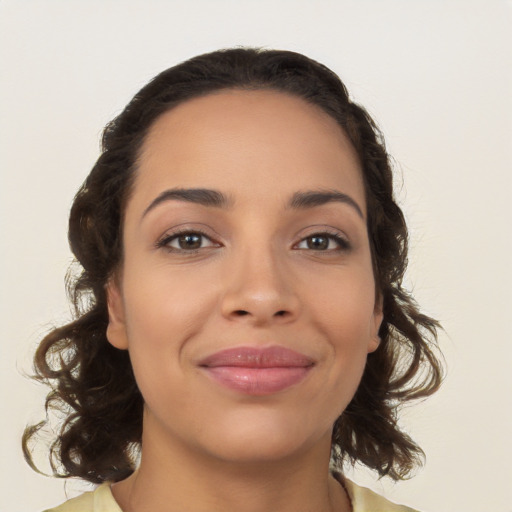 Joyful latino young-adult female with medium  brown hair and brown eyes