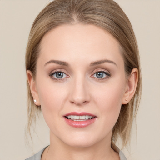 Joyful white young-adult female with medium  brown hair and blue eyes