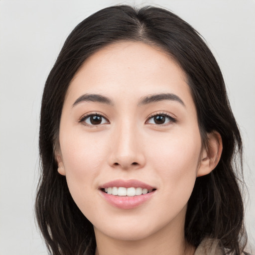 Joyful white young-adult female with long  black hair and brown eyes