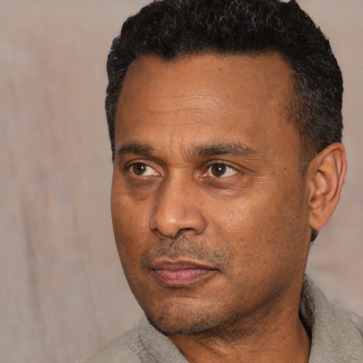 Neutral latino adult male with short  black hair and brown eyes