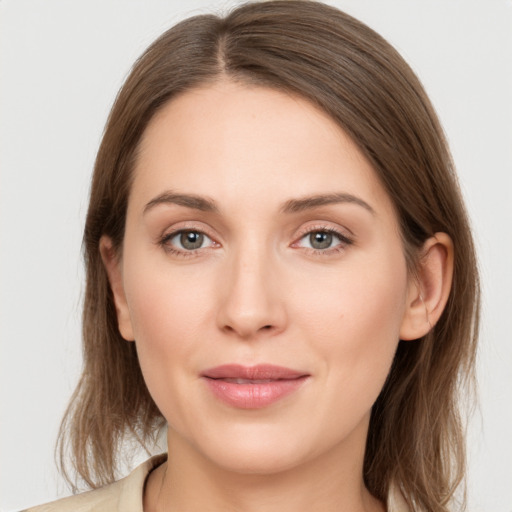 Joyful white young-adult female with medium  brown hair and grey eyes