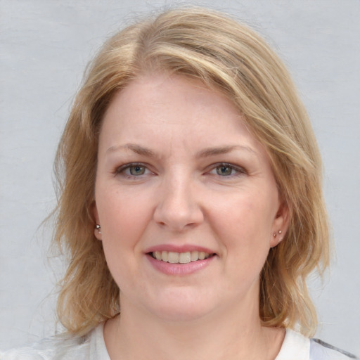 Joyful white young-adult female with medium  brown hair and blue eyes