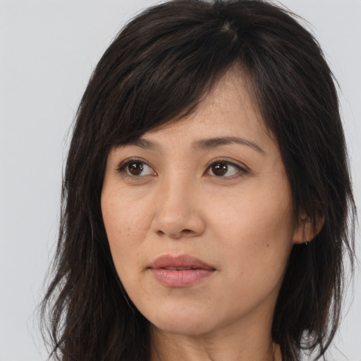 Joyful asian young-adult female with long  brown hair and brown eyes